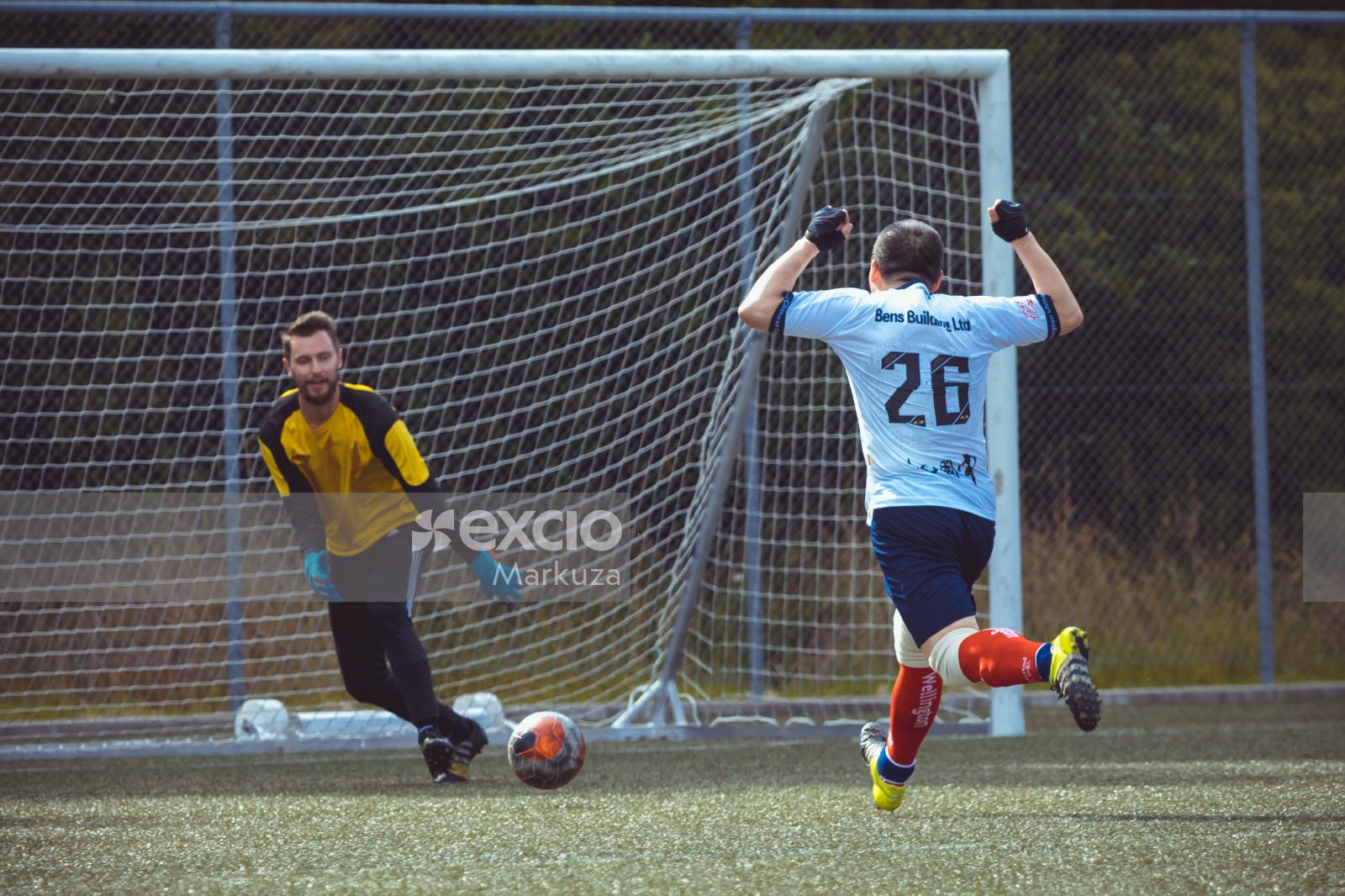 Football player raising both hands in the air - Sports Zone sunday league