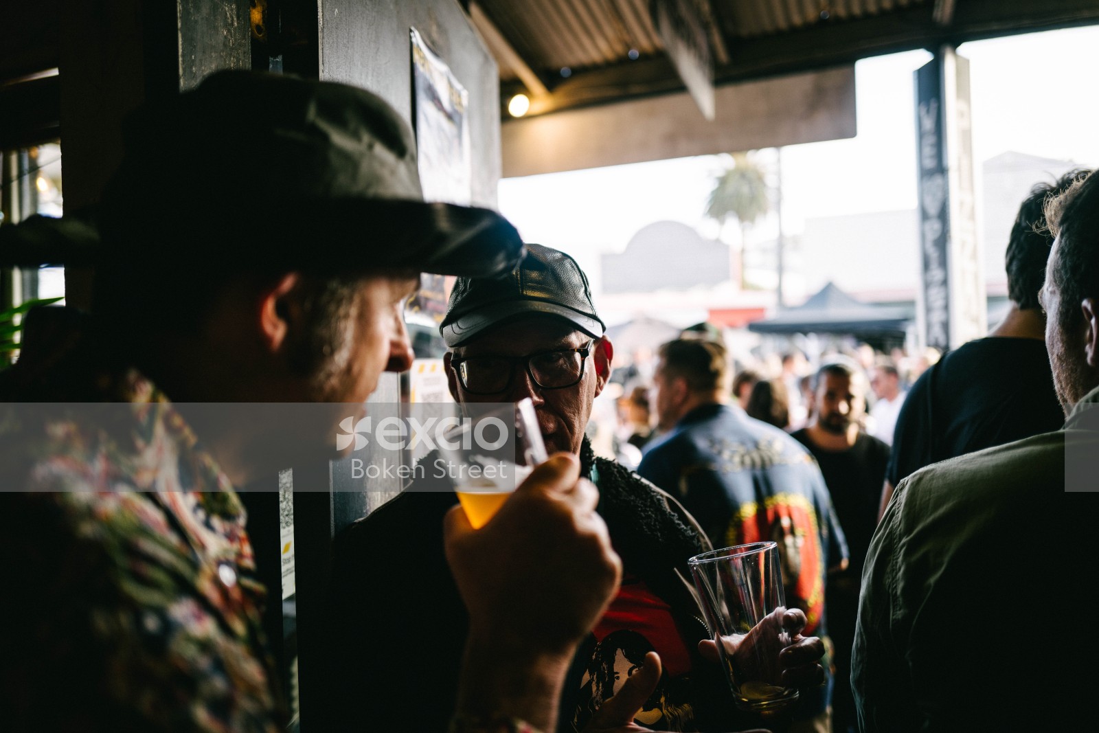 Two men drinking beer and conversating at Newtown festival 2021