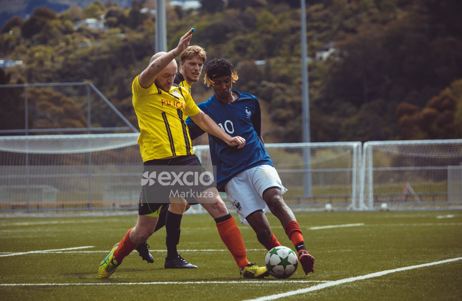 Blue shirt player tackling yellow shirt player - Sports Zone sunday league