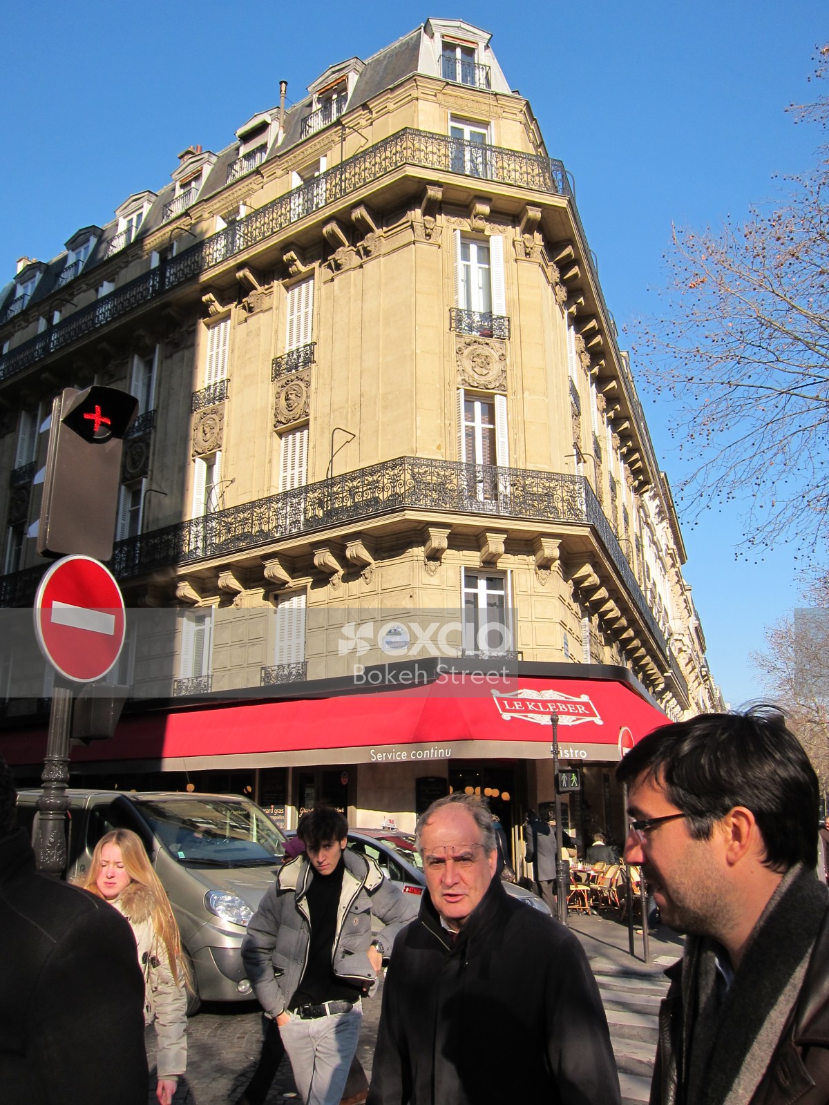 People in the street and Le Kleber restaurant in Paris