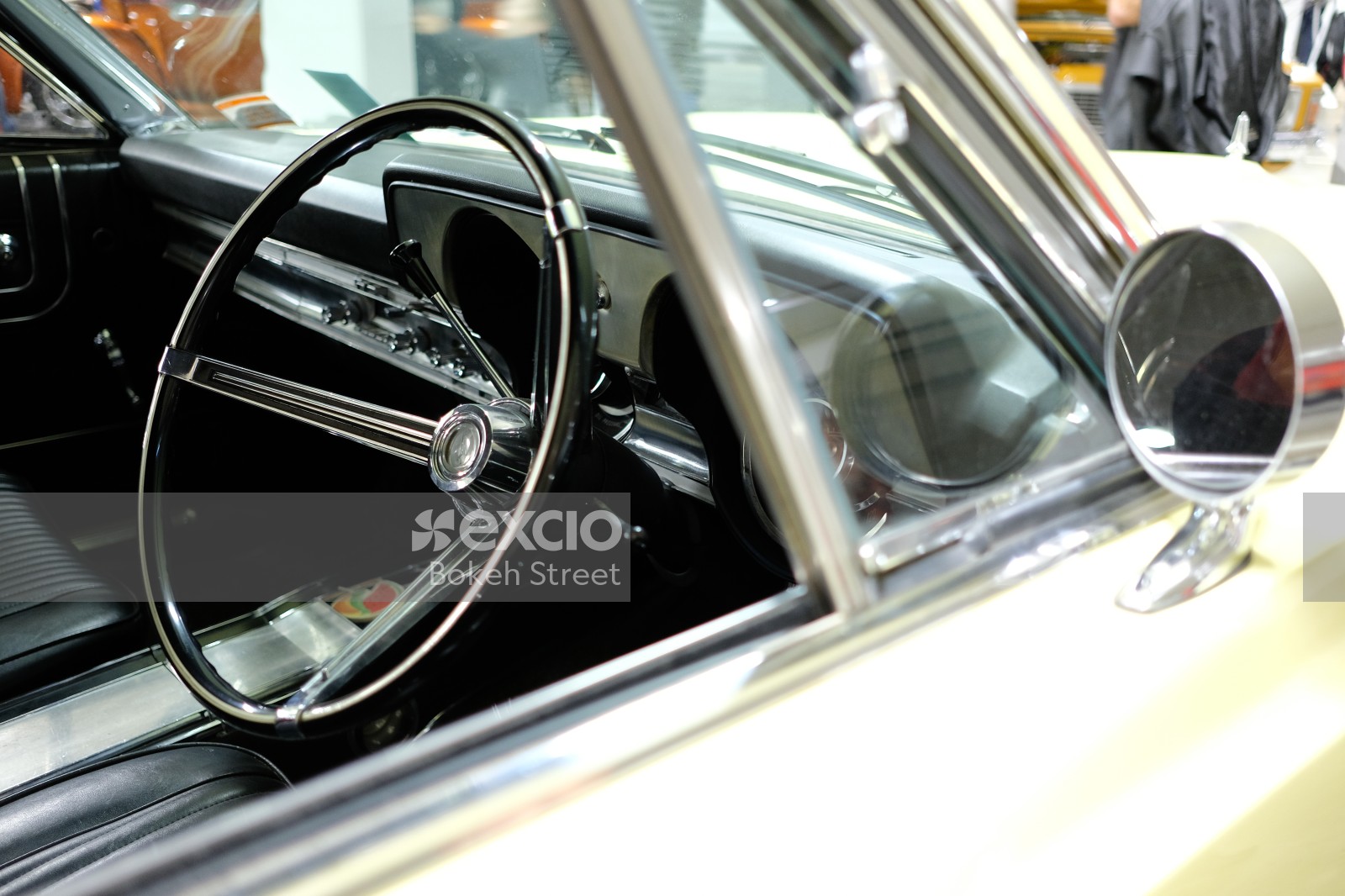 Classic white car black interior steering wheel and A-pillar window
