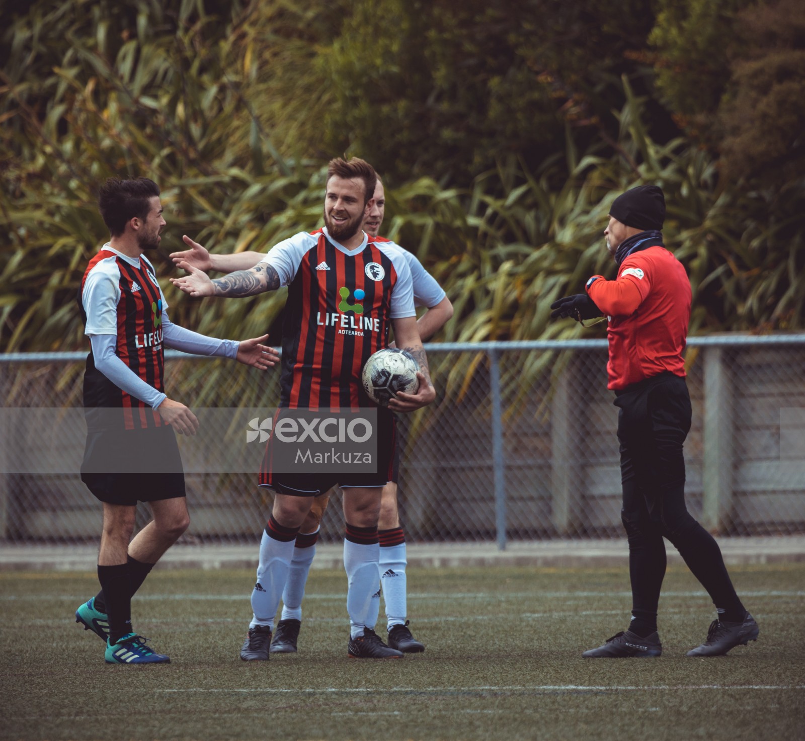 Player holding football talking to referee - Sports Zone sunday league