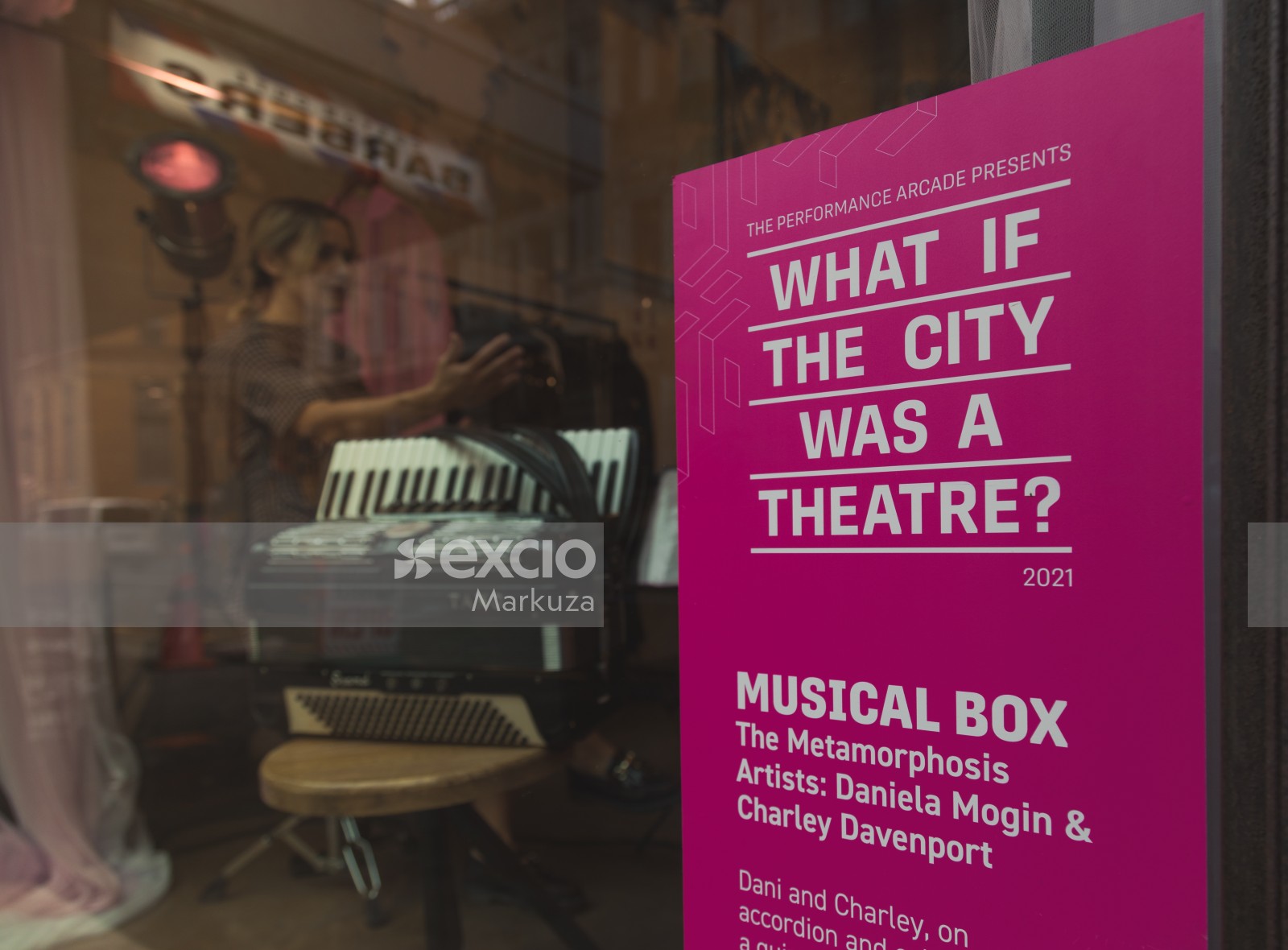 What if the city was a theatre? poster on a shop's glass