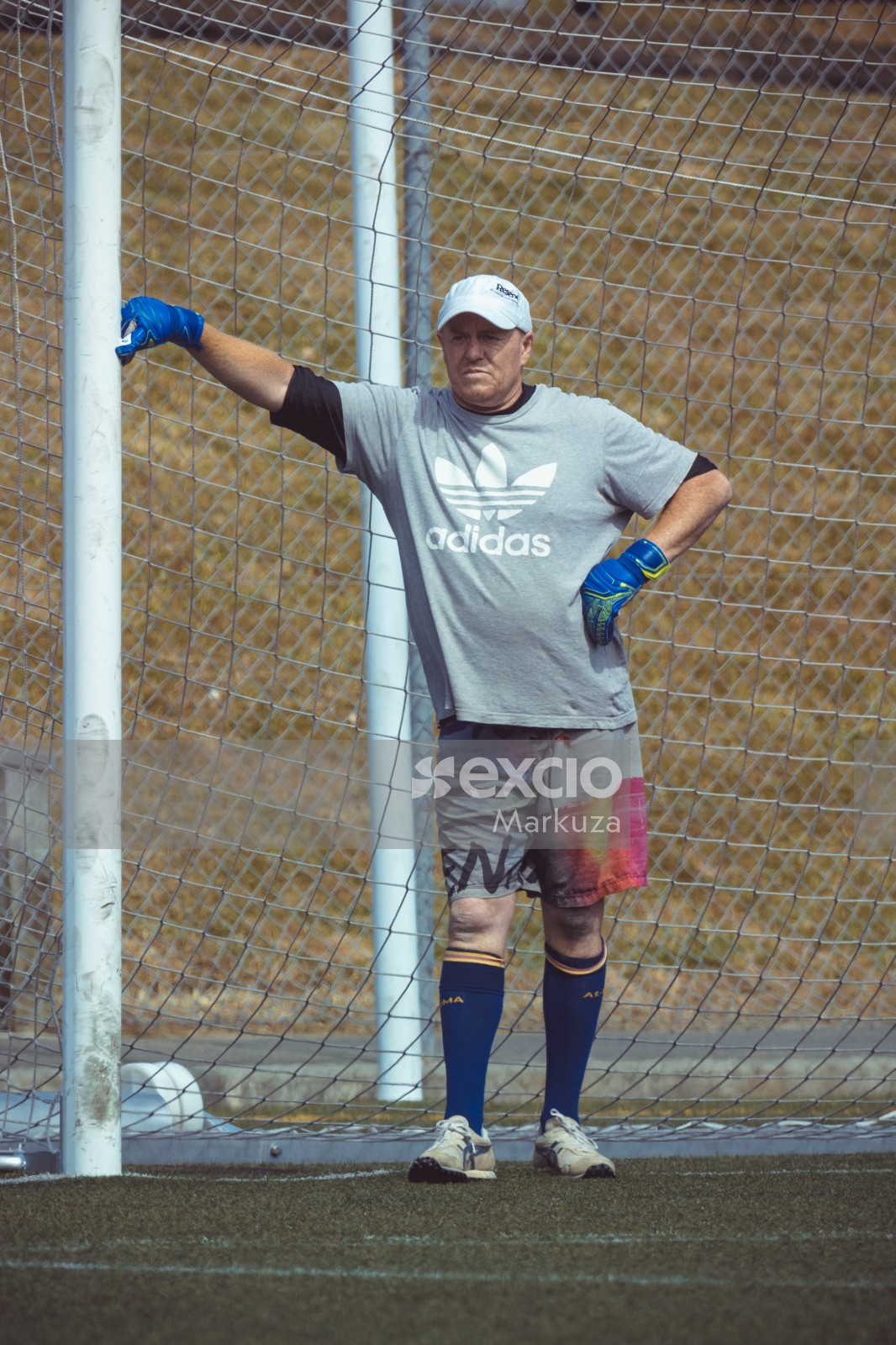 Goalkeeper resting with a goalpost - Sports Zone sunday league