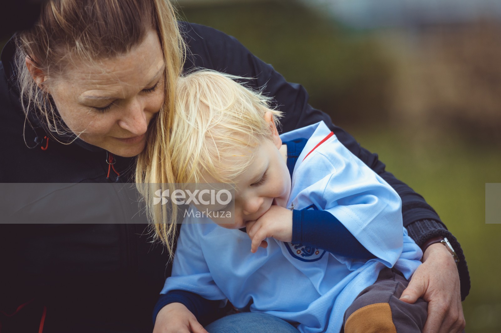 Mother with blonde haired son wearing England kit - Little Dribblers