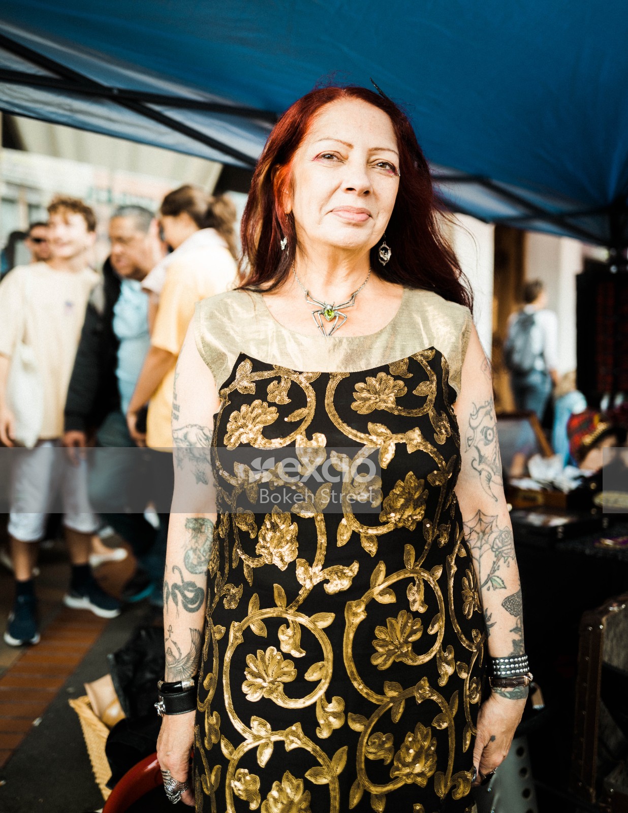 Woman with tattooed arms and spider necklace at Newtown festival 2021