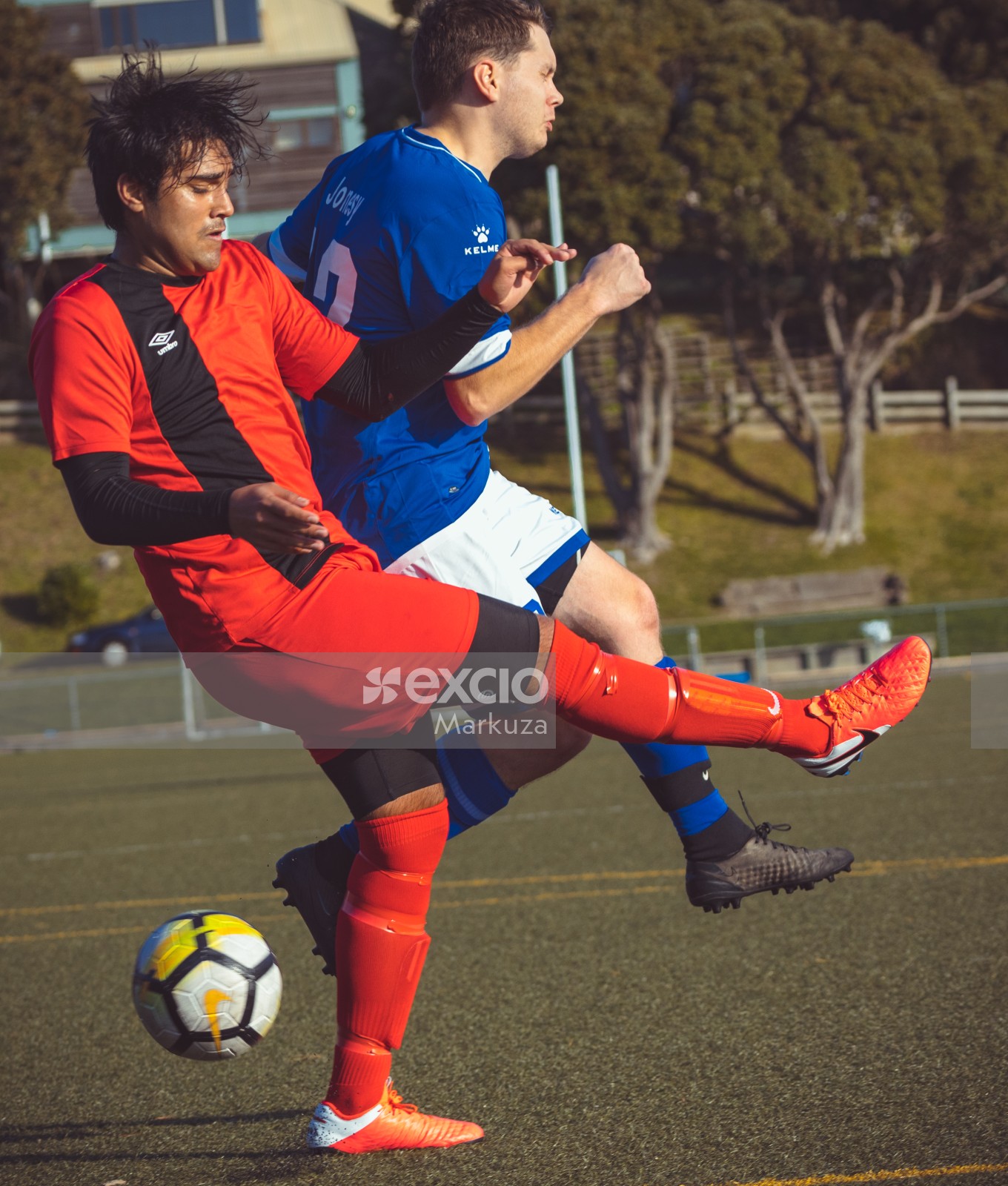 Player in red Umbro shirt kicks Nike football - Sports Zone sunday league