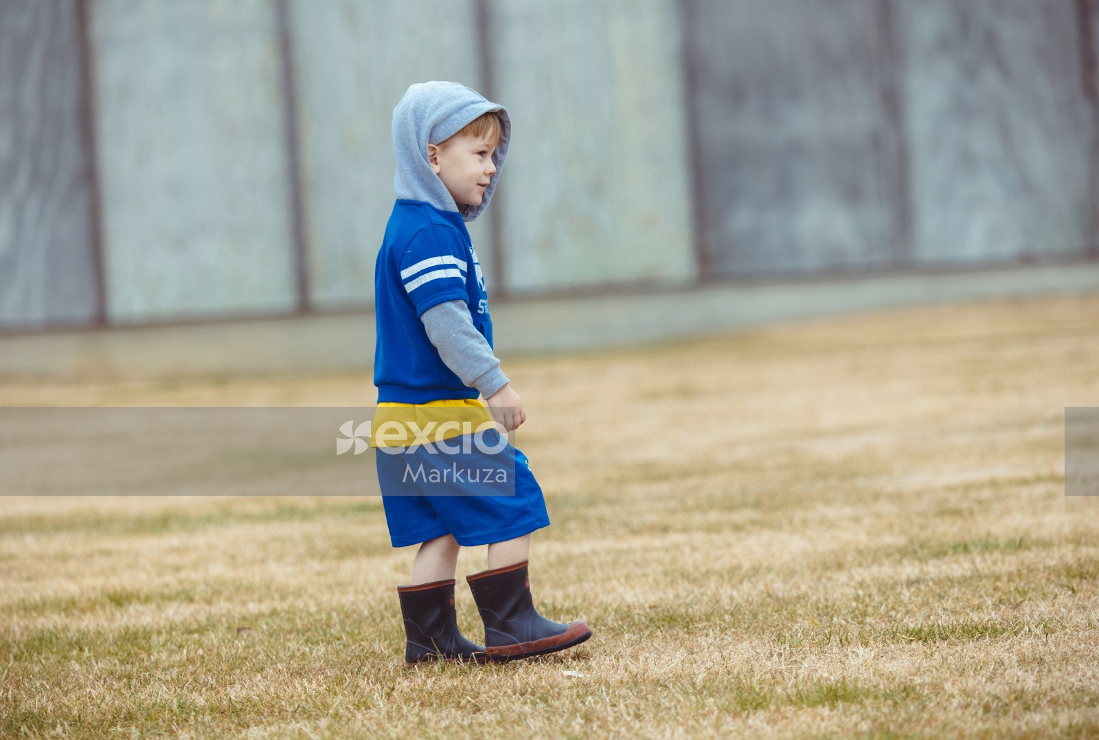 Little boy in blue outfit and high boots at Little Dribblers soccer contest