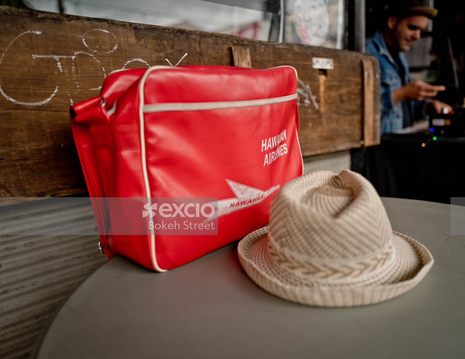Red Hawaiian airlines bag and fedora hat at Newtown festival 2021