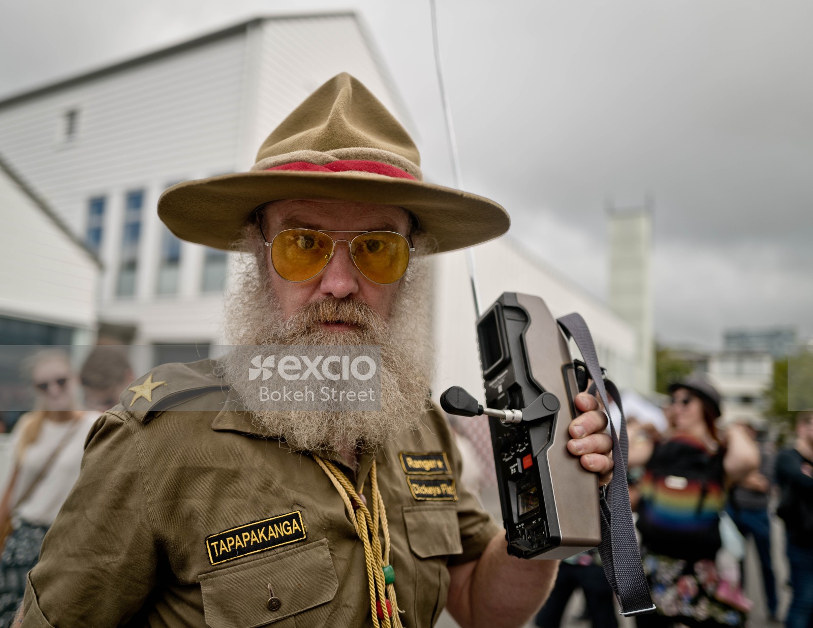 Portrait of a park ranger wearing orange shades at Newtown festival 2021 bokeh