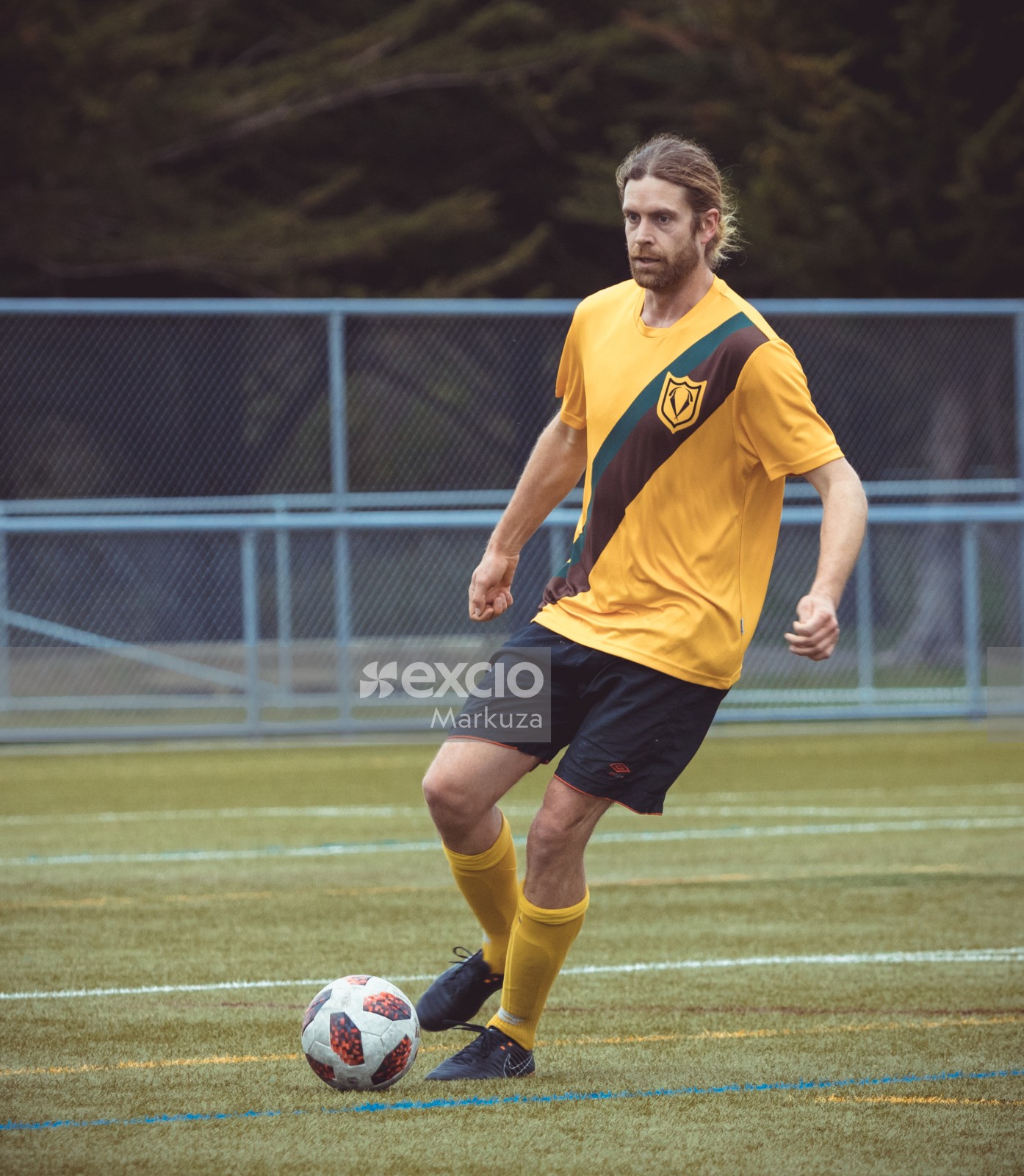 Player in yellow shirt taking a turn running with the football - Sports Zone sunday league