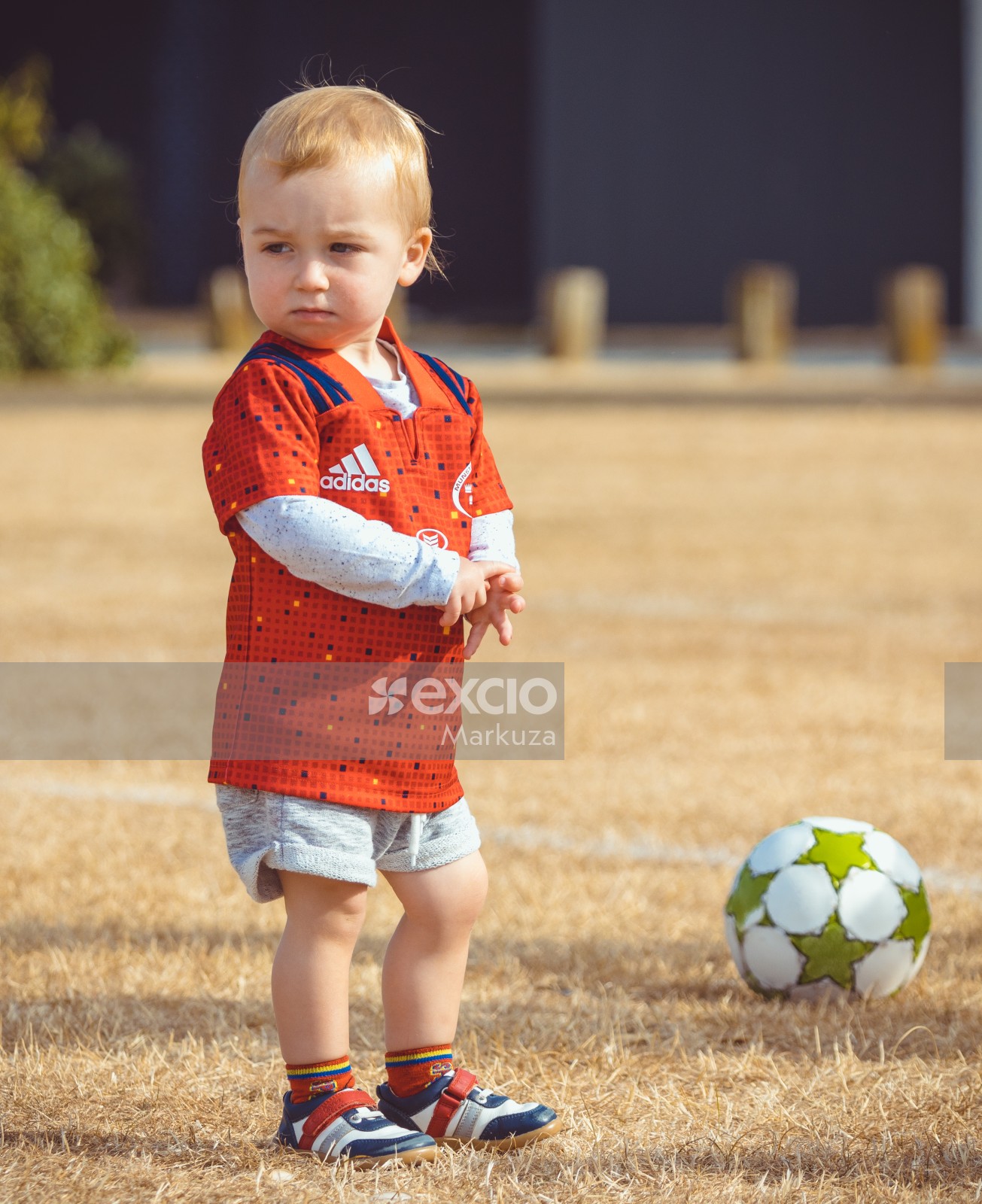Boy wearing orange Adidas shirt - Little Dribblers