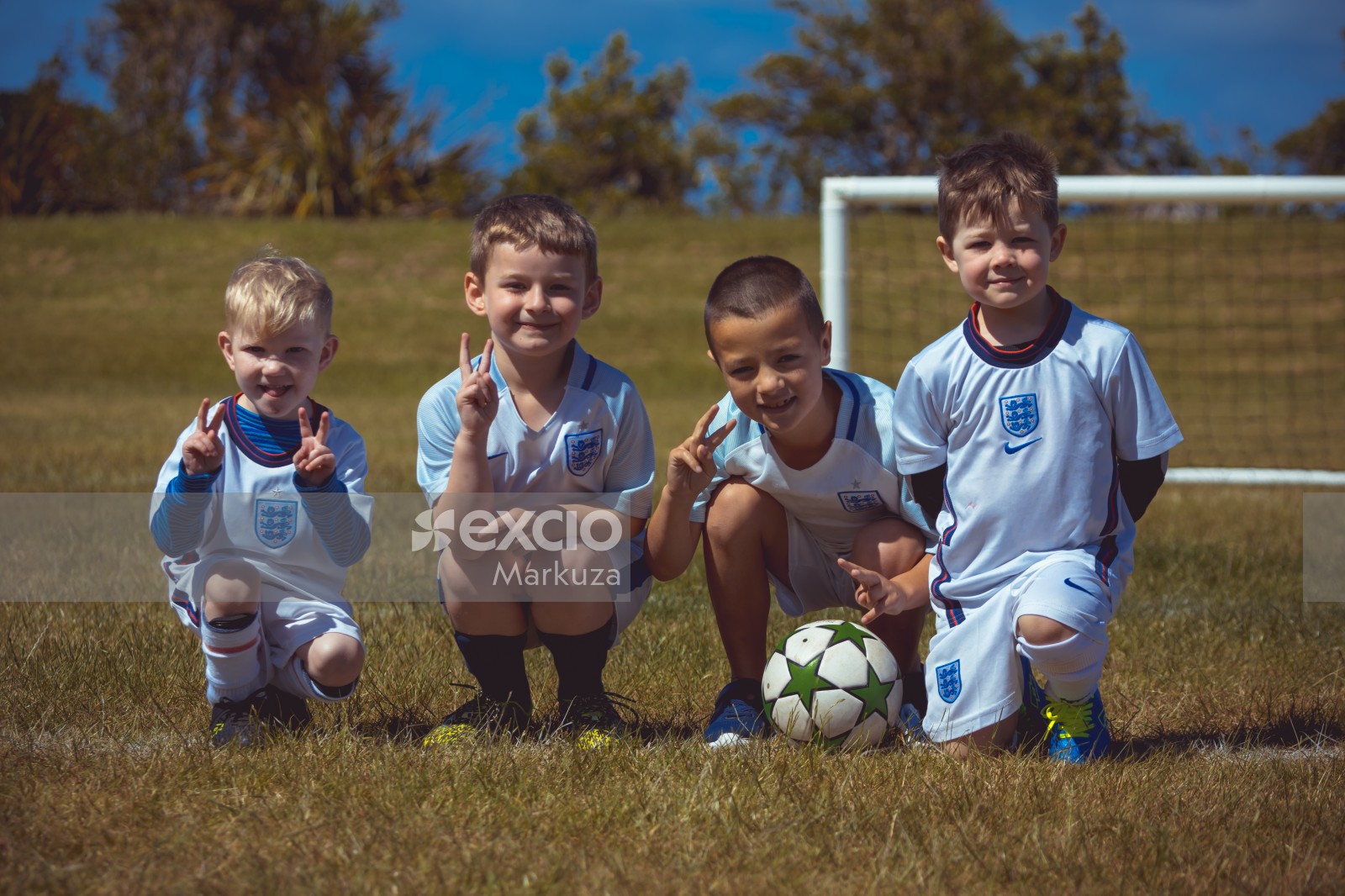 Four boys wearing England kit posing for a photo - Little Dribblers